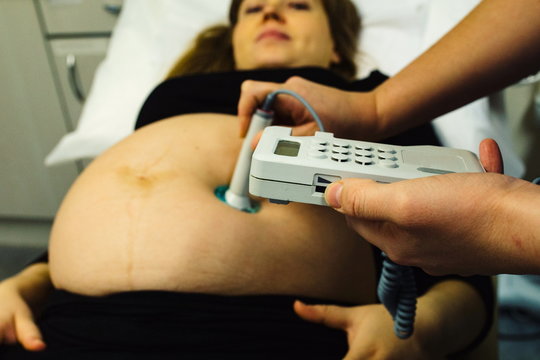 pregnant woman checked by midwife 