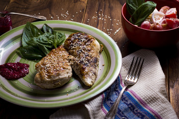 healthy food - grilled chicken with vegetables on a wooden board
