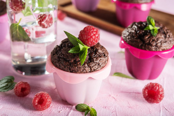 Sweet chocolate cupcake on pink background