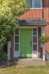 Fototapeta na wymiar Green paint old house wood door entrance
