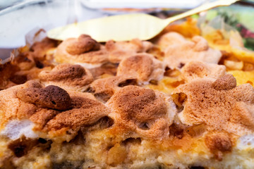 Casserole of semolina, cottage cheese and finely chopped apples close-up.