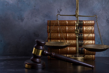 Law and justice concept - law gavel with scale and row of books, retro toned