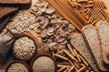 Wooden table full of fiber-rich wholegrain foods, perfect for a balanced diet - obrazy, fototapety, plakaty