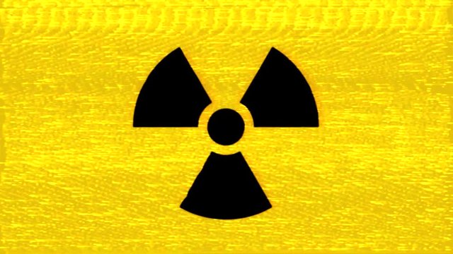 A radiation warning symbol (shown near radioactive materials i.e. nuclear plants, toxic waste dumps), appearing with a heavy analog VHS distortion effect.
