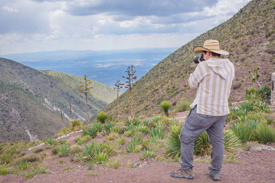Man shooting a beautiful cactus landscape at Real de Catorce desert in San Luis Potosi, Mexico 