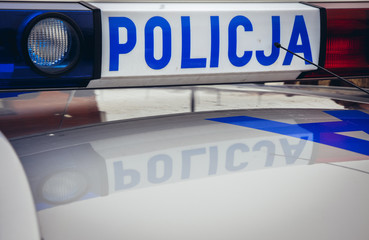 Police sign on a emergency lighting of police vehicle in Warsaw, Poland © Fotokon