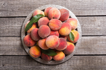 Ripe peaches fruit on rustic background