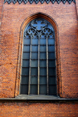 Gothic window in red brick wall of St. Saviour's Anglican Church, Riga, Latvia, July 20, 2018