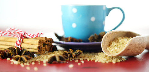 Coffee sugar, cinnamon and star anise coffee sweetener macro closeup on vintage red wood table, selective focus.