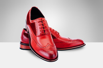 Red men's shoes on split background