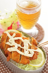 Homemade Japanese bento packed lunch, fried chicken and tartar sauce on rice
