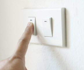 hand switching light power switch on or off.