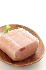 Canned food, luncheon meat on wooden plate