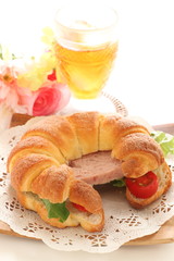 Luncheon meat in croissant sandwich