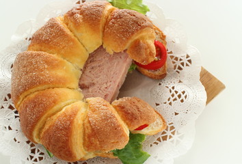 Luncheon meat in croissant sandwich