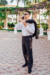 Young businessman talking on his phone outdoors