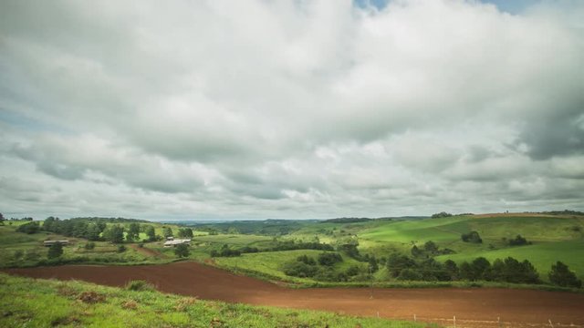 Timelapse of clouds passing by a rural landscape with a dirt road.  Frei Rog&eacute;rio, Santa Catarina / Brazil