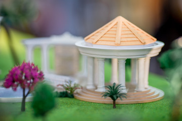 Background, house models (small trees, cars, grass, parking space) are shown to customers before the introduction of the service.