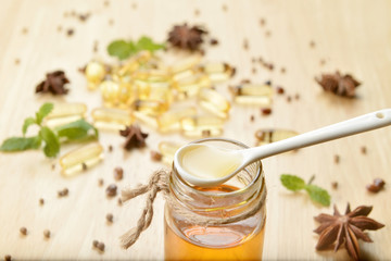 Fish oil on bottle with spoon on brown wooden background with  many fish oils.