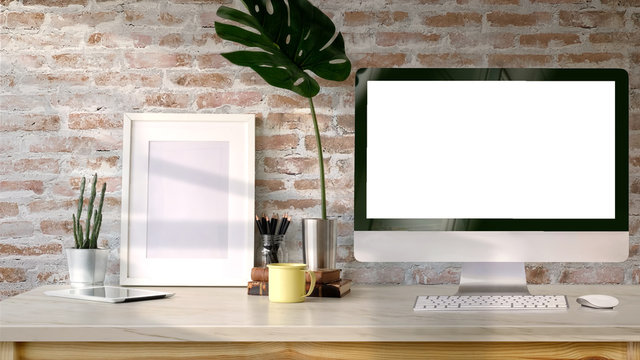 Loft workspace, Blank screen desktop computer and mockup poster on desk.