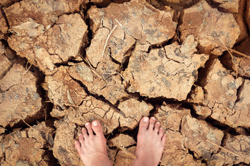 foot stand on cracked dry land without water - color effect