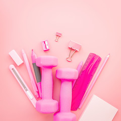 pink stationery on pink background with copy space flat lay top view