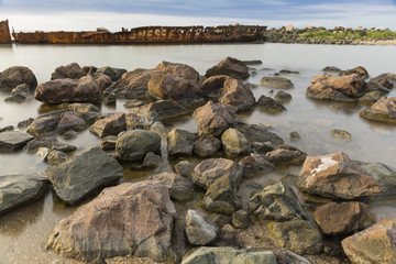 The beach with stones. Big stones on the beach. Morning inflow of water. Bulgaria, Burgas, Nessebar, Olympic Hope beach