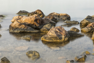 The beach with stones. Big stones on the beach. Morning inflow of water. Bulgaria, Burgas, Nessebar, Olympic Hope beach