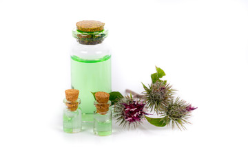 organic burdock oil in glass bottles on white background