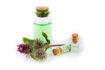 bottle with burdock oil isolated on white