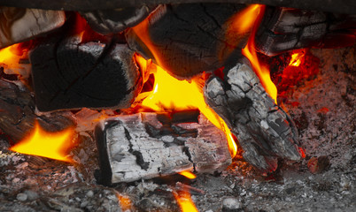 Coals in a hot fire close up.