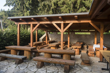 Fototapeta na wymiar Pergola with wooden seating.