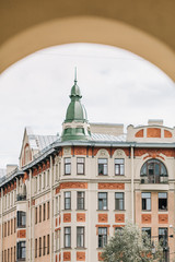 View through the arch to the house of European architecture on Vasilievsky Island in St. Petersburg city