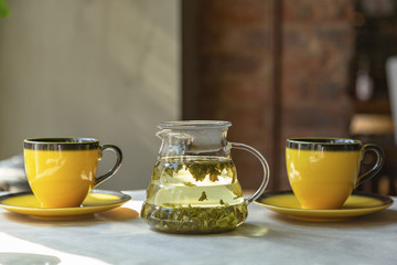 Tea in the morning, two cups of green tea on the table in the cafe.