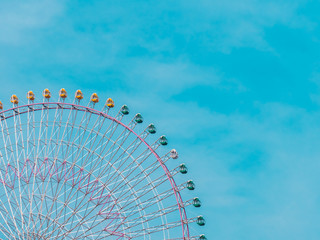 Ferris wheel in the park with blue sky background