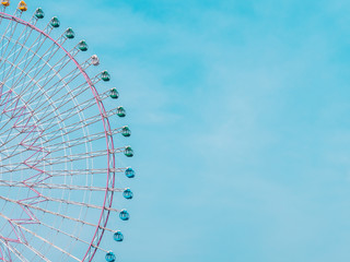 Ferris wheel in the park with blue sky background