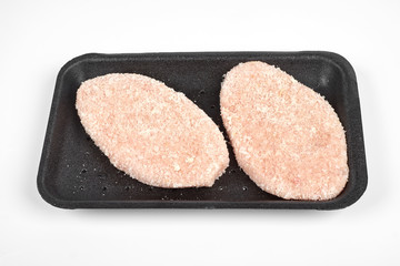 raw delicious chicken cutlet in package. Isolated on a white background.