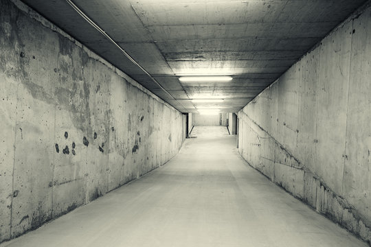 Empty downhill ramp of an underground car parking. Black and white image