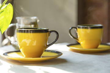 Green tea, two cups of tea on the coffee table. Blurred background.