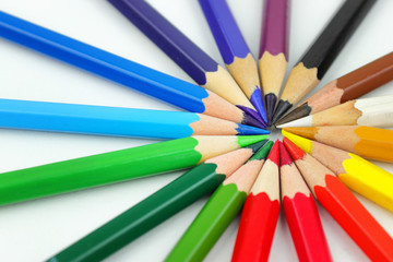 Circle of colored pencils on a white background