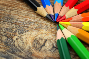 Color wheel from a color spectrum of stationery crayons on wooden