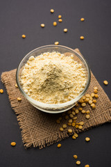 Besan, Gram or chickpea flour or powder is a pulse flour made from a variety of ground chickpea known as Bengal gram. popular ingredient for Pakora/pakoda or bajji snack. Selective focus