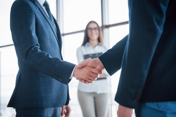 Two confident business man shaking hands during a meeting in the office, success, dealing, greeting...
