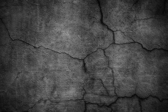 Black cement wall. Dark texture of cracked concrete