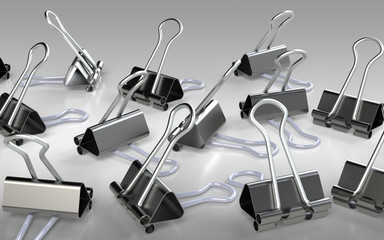 Obraz premium Several binder clips placed on the grey background