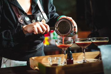 championship among coffee houses, members of teams show barista's skill, prepare drinks, teamwork. pours drink into glasses