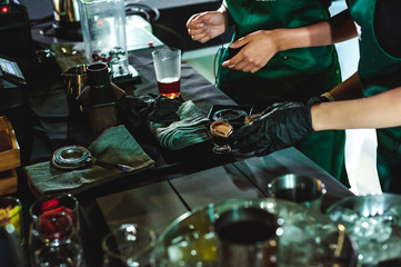 championship among coffee houses, members of teams show barista's skill, prepare drinks, teamwork