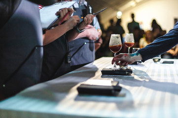 business woman makes notes on a sheet in a notebook, at a restaurant art contest, at a championship...