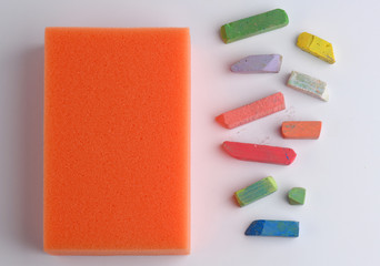 Pieces of chalk and sponge for chalkboard. School concept