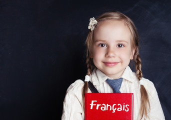 Cheerful little girl learning french. Learning french language concept
